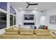 Bright open living room featuring a contemporary fireplace, modern furniture, and a view of the backyard at 1594 Pontine Ct, Henderson, NV 89052