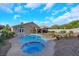 A backyard featuring a private pool, spa, landscaped garden, and a covered patio, perfect for outdoor living at 1594 Pontine Ct, Henderson, NV 89052