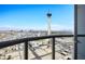 Balcony view of Las Vegas, showcasing The Strat hotel, cityscape, and distant mountains against a bright blue sky at 200 W Sahara Ave # 3312, Las Vegas, NV 89102