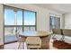 Dining area with round table, modern chairs, hardwood floors, and a large window showcasing city views at 200 W Sahara Ave # 3312, Las Vegas, NV 89102