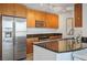 Modern kitchen featuring stainless steel appliances, wooden cabinets, and a granite countertop at 200 W Sahara Ave # 3312, Las Vegas, NV 89102