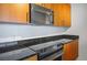Close up of kitchen with granite countertops, stainless steel oven, and wooden cabinetry at 200 W Sahara Ave # 3312, Las Vegas, NV 89102