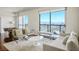 Modern living room featuring stylish seating, hardwood floors, and floor-to-ceiling windows showcasing an expansive city view at 200 W Sahara Ave # 3312, Las Vegas, NV 89102