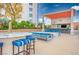 Stylish outdoor kitchen featuring seating, bar, television and colorful decor for enjoyable entertainment at 200 W Sahara Ave # 3312, Las Vegas, NV 89102