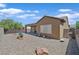 Spacious backyard with covered patio, gravel landscaping, and a secure fence at 2091 Waterton Rivers Dr, Henderson, NV 89044