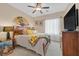 Cozy bedroom featuring a ceiling fan, comfortable bed, and a bedside table at 2091 Waterton Rivers Dr, Henderson, NV 89044