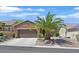 Charming single-story home featuring a well-maintained lawn and a mature palm tree in a desert landscaped front yard at 2091 Waterton Rivers Dr, Henderson, NV 89044
