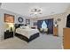 Spacious main bedroom featuring a ceiling fan, large window, and comfortable furniture at 2091 Waterton Rivers Dr, Henderson, NV 89044