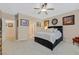 Spacious main bedroom featuring a ceiling fan, neutral walls, carpet flooring, and a comfortable bed at 2091 Waterton Rivers Dr, Henderson, NV 89044
