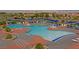 Aerial view of an outdoor pool area with lounge chairs and umbrellas at 2091 Waterton Rivers Dr, Henderson, NV 89044