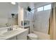 This bathroom has a shower-tub combo with a white vanity and a decorative palm tree accent at 2180 Tiger Links Dr, Henderson, NV 89012