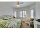 Cozy bedroom featuring white furniture, a ceiling fan, and large windows with plantation shutters at 2180 Tiger Links Dr, Henderson, NV 89012
