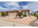 Charming single-story home featuring a two-car garage and low-maintenance desert landscaping at 2180 Tiger Links Dr, Henderson, NV 89012