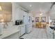 Open kitchen with white tile flooring, matching appliances and a breakfast nook at 2180 Tiger Links Dr, Henderson, NV 89012