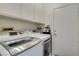 This laundry room has a white washer and dryer set, plus extra storage space at 2180 Tiger Links Dr, Henderson, NV 89012