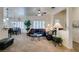 Comfortable living room featuring neutral carpeting and bright white walls open to a dining area at 2180 Tiger Links Dr, Henderson, NV 89012