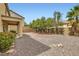 Desert-landscaped backyard with a seating area and a block wall at 224 Pioneers Peak Ave, Henderson, NV 89002
