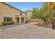 View of the backyard from beneath a covered porch, featuring gravel and desert landscaping at 224 Pioneers Peak Ave, Henderson, NV 89002