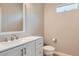Half-bathroom with a white vanity, modern faucet, and a toilet at 224 Pioneers Peak Ave, Henderson, NV 89002