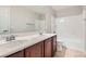 Well-lit bathroom featuring a double sink vanity and a shower-tub combo at 224 Pioneers Peak Ave, Henderson, NV 89002