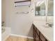 Bathroom featuring a tub, single sink vanity, and mirror at 224 Pioneers Peak Ave, Henderson, NV 89002