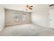 Spacious bedroom with neutral carpet, two windows, and ample natural light at 224 Pioneers Peak Ave, Henderson, NV 89002