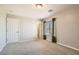 Bedroom with neutral carpet, a window with curtains, and white doors at 224 Pioneers Peak Ave, Henderson, NV 89002