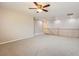 Large bonus room with plush carpet and a staircase with wood banister at 224 Pioneers Peak Ave, Henderson, NV 89002