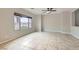 Large bonus room with tile floors, a ceiling fan, neutral walls, and a bright window at 224 Pioneers Peak Ave, Henderson, NV 89002