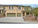 Two-story home featuring a three-car garage, desert landscaping, and neutral color palette at 224 Pioneers Peak Ave, Henderson, NV 89002
