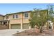Two-story home showcasing a three-car garage, simple landscaping, and neutral color palette at 224 Pioneers Peak Ave, Henderson, NV 89002