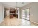 Open kitchen featuring stainless appliances, an island, and adjacent dining area with backyard access at 224 Pioneers Peak Ave, Henderson, NV 89002