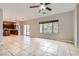 Bright living room featuring tile floors, a ceiling fan, and backyard access at 224 Pioneers Peak Ave, Henderson, NV 89002
