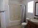 Bathroom offers a shower-tub combo, a granite countertop, and natural light at 2381 Lilac Cove St, Las Vegas, NV 89135