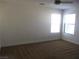 Bright bedroom with carpet flooring and windows providing natural light at 2381 Lilac Cove St, Las Vegas, NV 89135