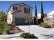 Charming two-story house with well-maintained landscaping and a driveway leading to the garage at 2381 Lilac Cove St, Las Vegas, NV 89135