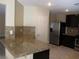 Updated kitchen featuring stainless steel appliances, granite counters and a breakfast bar at 2381 Lilac Cove St, Las Vegas, NV 89135
