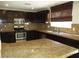 Well-equipped kitchen featuring granite counters, stainless steel appliances, and dark cabinets at 2381 Lilac Cove St, Las Vegas, NV 89135