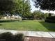A beautiful view of the neighborhood park, showcasing mature trees and a walking path at 2381 Lilac Cove St, Las Vegas, NV 89135