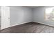 Empty bedroom with light blue walls, wood floors, and a bright window view at 2451 N Rainbow Blvd # 1016, Las Vegas, NV 89108