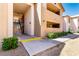 Inviting condo complex with desert landscaping, covered walkways, and visible stairs at 2451 N Rainbow Blvd # 1016, Las Vegas, NV 89108