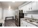Bright kitchen featuring stainless steel appliances, a double sink, and modern gray flooring at 2451 N Rainbow Blvd # 1016, Las Vegas, NV 89108