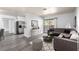 Comfortable living room features a large sectional sofa, decorative rug, and sliding glass door to outdoor balcony at 2451 N Rainbow Blvd # 1016, Las Vegas, NV 89108
