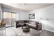 Comfortable living room features a large sectional sofa, decorative rug, and sliding glass door to outdoor balcony at 2451 N Rainbow Blvd # 1016, Las Vegas, NV 89108