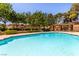 Relaxing community pool surrounded by lush trees and landscaping at 2451 N Rainbow Blvd # 1016, Las Vegas, NV 89108
