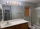 Full bathroom with large mirror, light fixture, single sink, and shower with glass doors at 258 Bella Matese Ave, Las Vegas, NV 89183