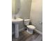 Powder room with a pedestal sink, modern toilet, and neutral wall colors at 258 Bella Matese Ave, Las Vegas, NV 89183