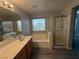 Bright bathroom with dual vanity, tub, standing shower, and neutral-toned walls and flooring at 258 Bella Matese Ave, Las Vegas, NV 89183