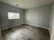 Clean bedroom with hardwood floors and a well-lit window at 258 Bella Matese Ave, Las Vegas, NV 89183