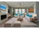 Bright living room featuring a fireplace, neutral tones, and modern furniture at 258 Bella Matese Ave, Las Vegas, NV 89183